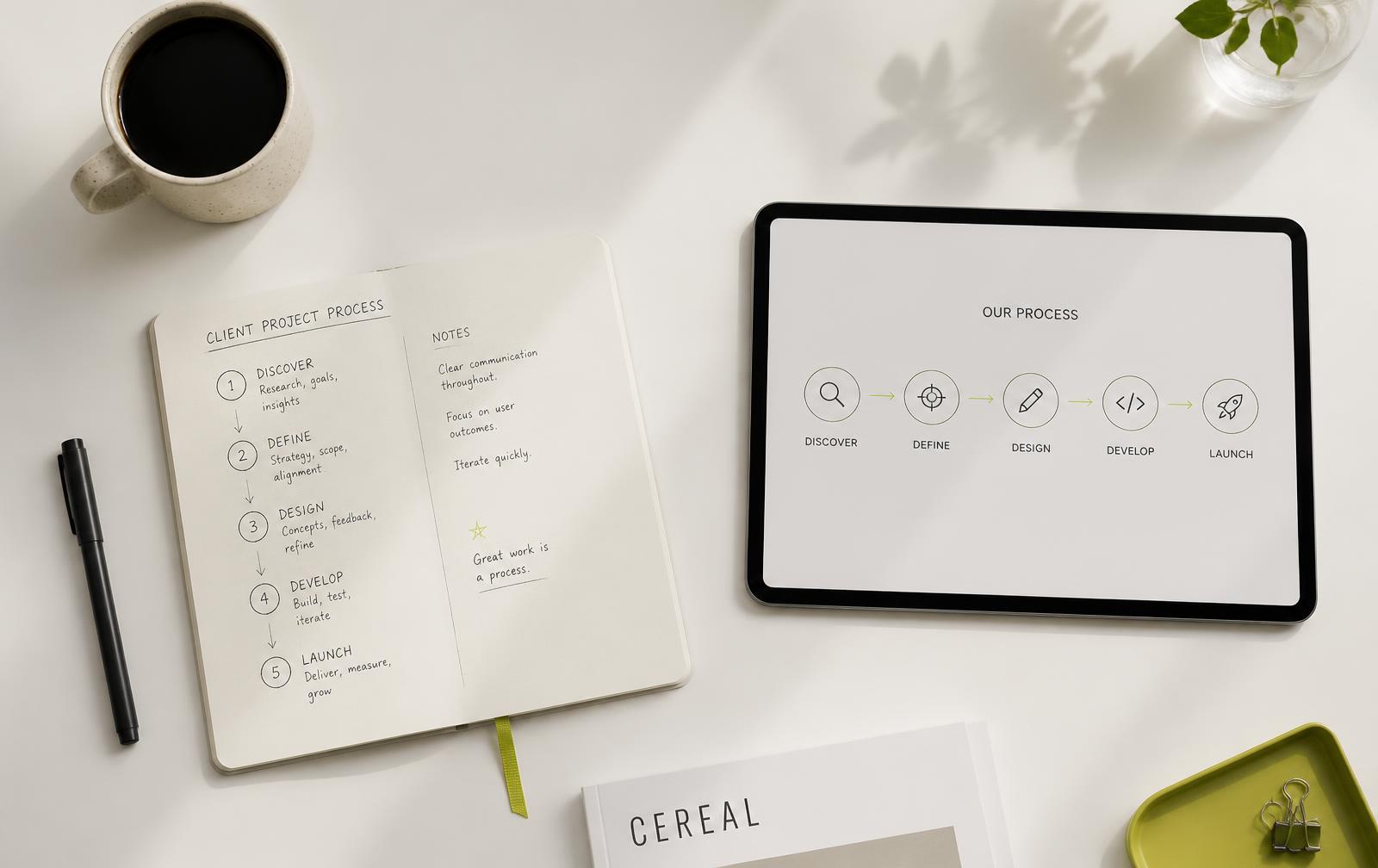 Notebook, pen and tablet showing a simple performance chart